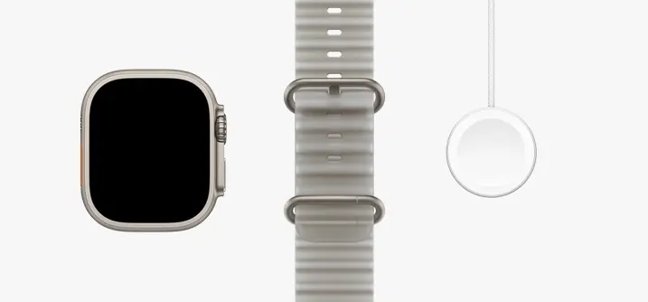 Apple Watch Ultra 4 — Natural titanium Ultra 4, translucent gray Ocean Band and USB-C charging cable.